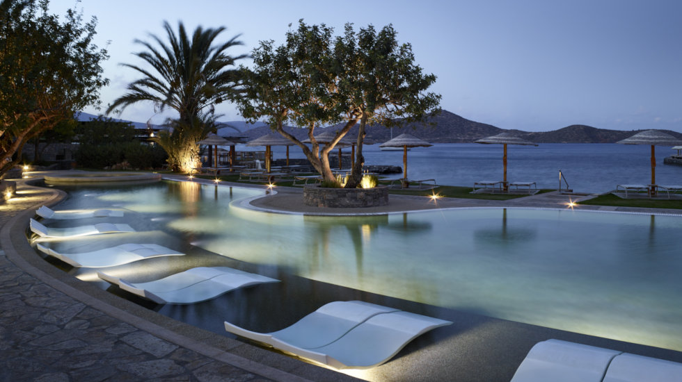 Porto Elounda Golf & Spa resort- side view of Main pool by the evening Porto Elounda Golf & Spa resort- side view of Main pool by the evening